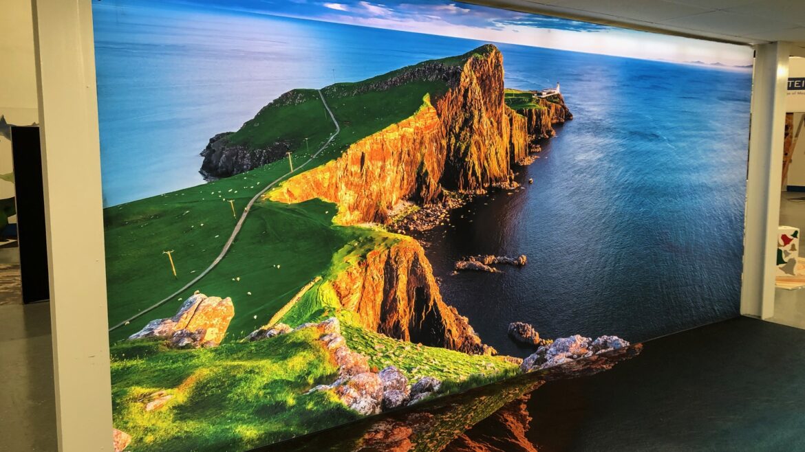 Large printed VorTex BLD300 soft signage fabric wall graphic of a coastal cliff installed in an interior space